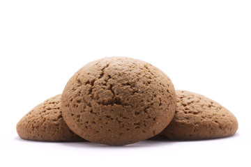Three round oatmeal cookies on white background
