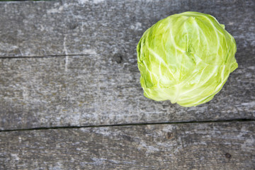 Fresh raw cabbage on wooden table. Top view. Copy space.