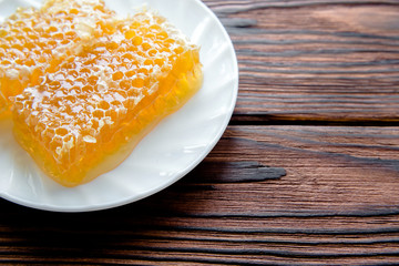 honey in honeycombs on a white plate 