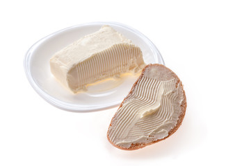 piece of butter in saucer, sandwich with butter isolated on white background