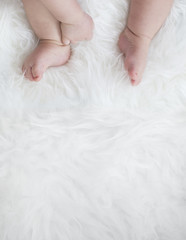baby feet on white blanket. copy space. selective focus