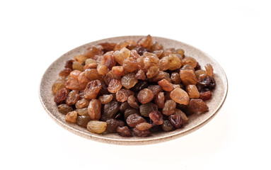 Raisin in plate on white background isolation, close-up