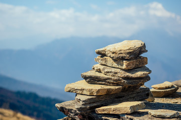 Pyramids of stones against the background of mountains. the concept of balance and tranquility.Yoga in the nature in the mountains