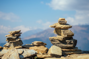 Pyramids of stones against the background of mountains. the concept of balance and tranquility.Yoga in the nature in the mountains
