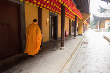 Shanghai, China - January 15, 2018: Minister of the Buddhist temple goes along the building in longhua temple