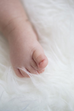 baby feet on white blanket. copy space. selective focus