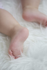 baby feet on white blanket. copy space. selective focus