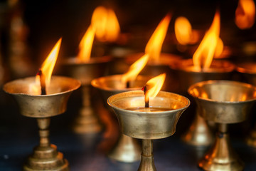 a prayer candle and a flame on a dark background. the concept of tragedy and mourning. spiritual...
