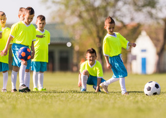 Young children players football match on soccer field