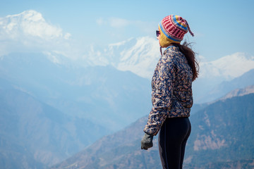 Smiling young beautiful and active woman in trekking in the mountains. the concept of active recreation and tourism in the mountains. trekking in Nepal Himalayas