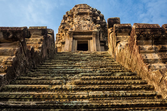 Very steep stairs, leading to one of the five redented towers, shaped like lotus buds, in the sanctuary of Angkor Wat in Siem Reap, Cambodia.