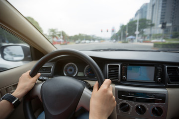 Driving car on city street wating infront of the traffic light