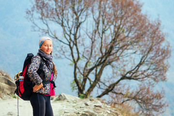 Smiling young beautiful and active woman in trekking in the mountains. the concept of active recreation and tourism in the mountains. trekking in Nepal Himalayas