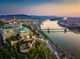 Budapest, Hungary - Aerial skyline view of Buda Castle Royal Palace and South Rondella with Castle District and Szechenyi Chain Bridge at sunrise