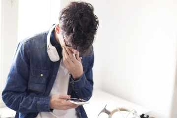 young with headphones and mobile phone