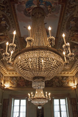 antique chandelier on the ceiling of a room of palazzo moroni