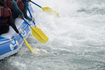 Close up of a team of people rafting on whitewater rapids - obrazy, fototapety, plakaty
