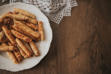 turkish cigarette patty on white plate and wooden table