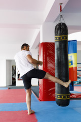 Kickbox fighter training in a gym with punch bags, see the whole series