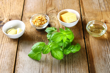 Ingredients for pesto sauce. Cheese, garlic, basil, pine nuts, olive oil.