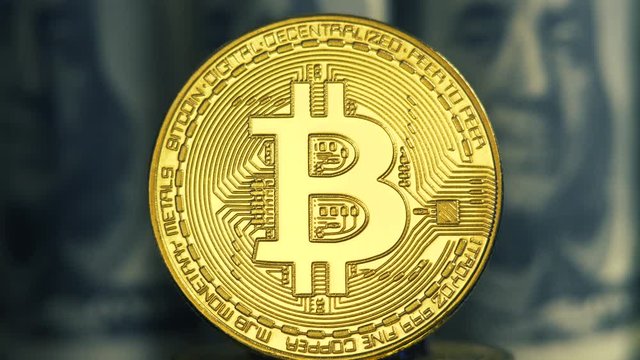 Crypto currency is bitcoin. BTK shoot close up. Bitcoin on dollars background. Blockchain technology