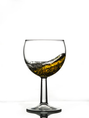 A beautiful splash of a foaming beverage in a glass