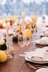 Served dinner table in a restaurant. Restaurant interior. Cozy restaurant table setting. Defocused background