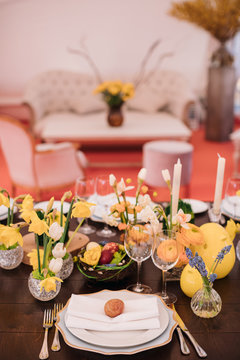 Easter table set in yellow green colors and eggs in the middle