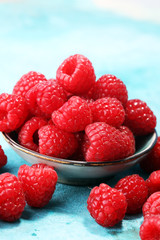 raspberries. Raspberry on blue background. Summer and healthy food concept