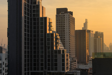 Fototapeta na wymiar urban cityscape on sunrise light pass through the building