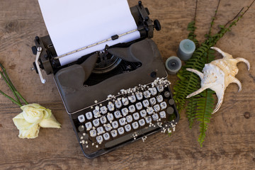 Writing and freelance concept. Vintage typewriter with flowers b