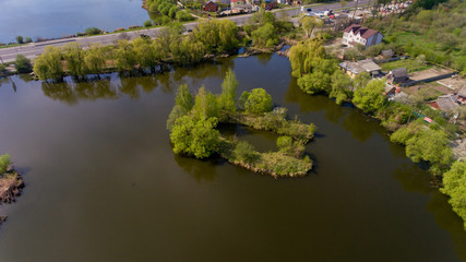 Obraz premium Aerial view of the small island in the city lake.
