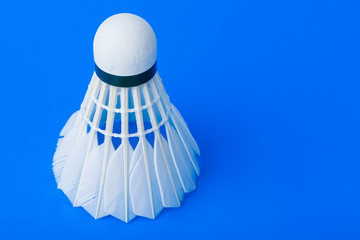 Fototapeta na wymiar Badminton shuttlecock on blue background