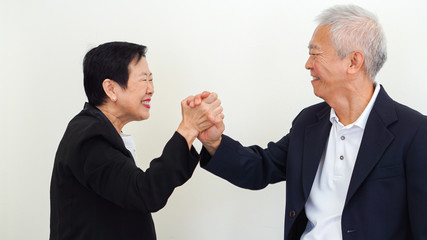Asian senior business people couple holding hand for successful life