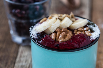 Smoothie with  blueberries, bananas, nuts, sunflower seeds and coconut flakes
