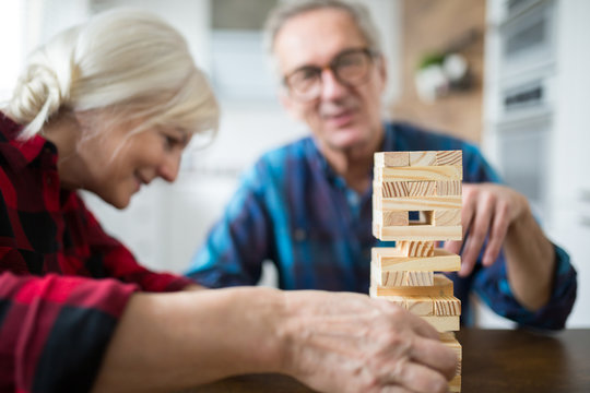 Happy Senior Marriage Playing Jenga Together