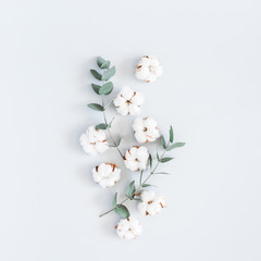 Flowers composition. Pattern made of cotton flowers and eucalyptus branches on pastel blue background. Flat lay, top view, square - 202008080