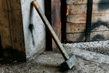 old sledgehammer standing in garage - obrazy, fototapety, plakaty