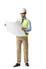 Thoughtful builder in reflective vest and helmet looking at blueprint isolated on white
