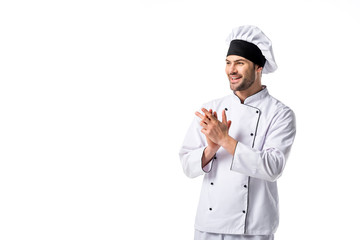 portrait of smiling chef in uniform and hat looking away isolated on white