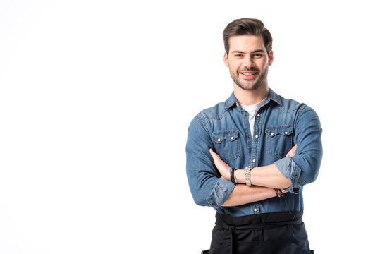 Portrait Of Smiling Waiter In Apron With Arms Crossed Isolated On White