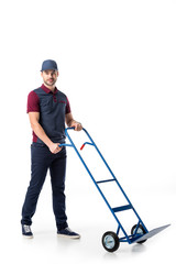 delivery man in uniform with empty hand truck isolated on white