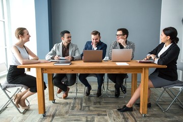 Group of businessmen working in the office at the table