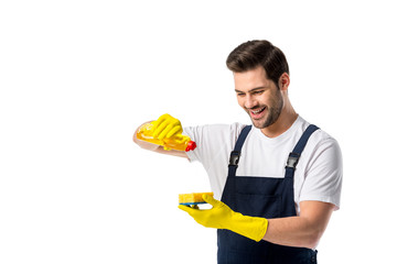 portrait of smiling cleaner in rubber gloves with detergent and sponge isolated on white