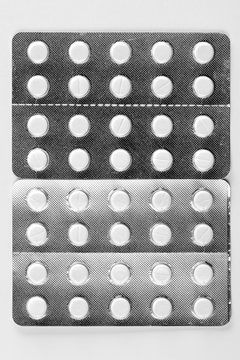 Packaged pills on white table