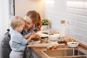 happy family in kitchen. mother and child baking cookies  .