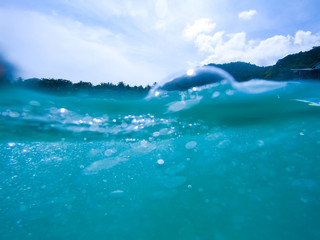 Underwater bubbles with sunlight through water surface, natural scene