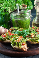 Bruschetta with fresh pesto, mozzarella and cherry tomatoes on cutting board