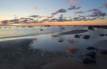 Beach sunset is a golden sky with a wave