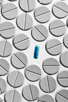 Blue capsule and white tablet pills